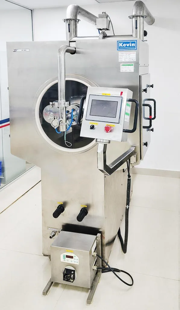 Close-up of the automatic tablet coater with perforated coating pan at Stabicon